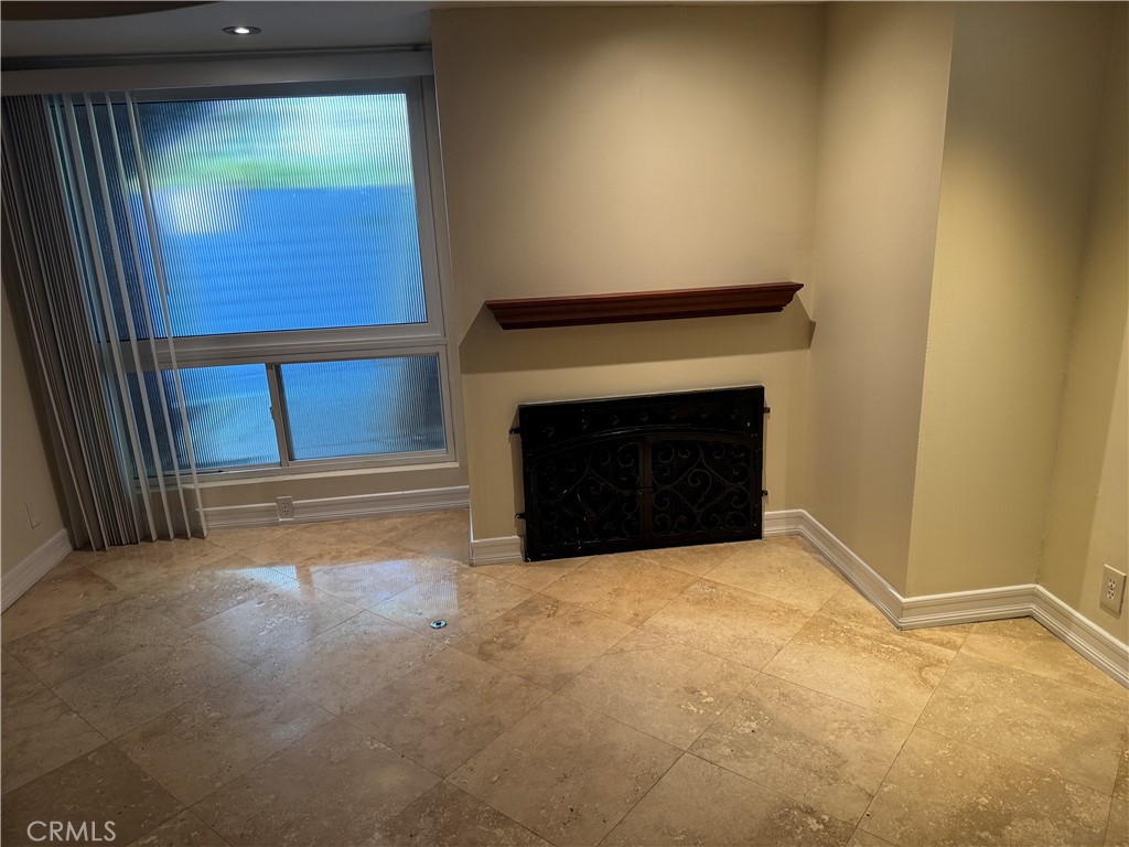 11370 Sunset Boulevard, Unit B Los Angeles, CA 90049 - Photo 21 of 27 a view of an empty room with a fireplace