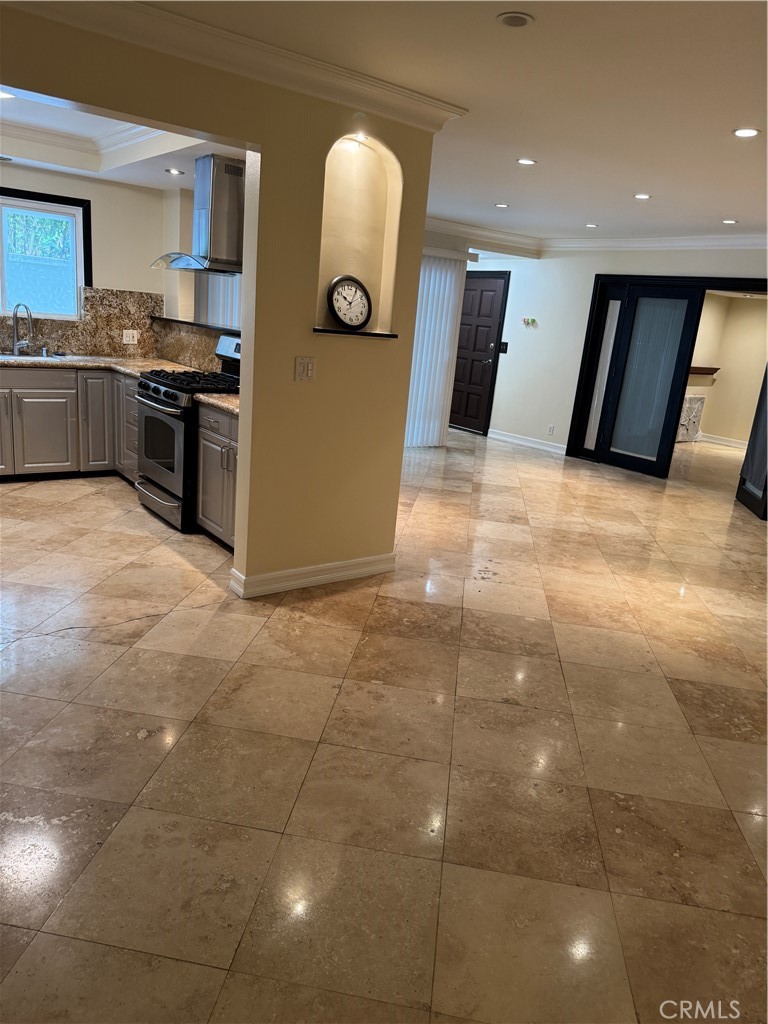 11370 Sunset Boulevard, Unit B Los Angeles, CA 90049 - Photo 25 of 27 a kitchen with stainless steel appliances granite countertop a stove a sink and a refrigerator