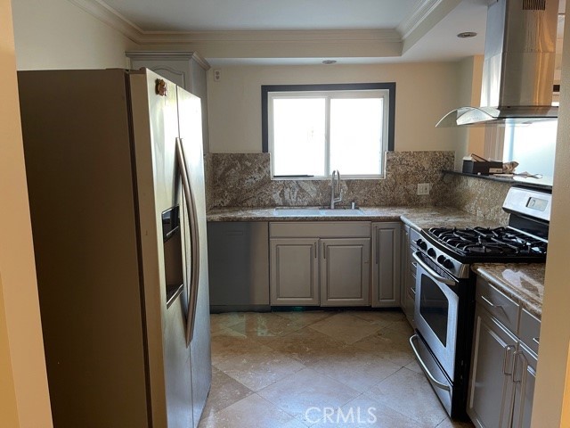 11370 Sunset Boulevard, Unit B Los Angeles, CA 90049 - Photo 3 of 27 a kitchen with stainless steel appliances granite countertop a stove a refrigerator and a sink