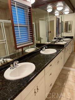 11370 Sunset Boulevard, Unit B Los Angeles, CA 90049 - Photo 9 of 27 a bathroom with a granite countertop sink and a mirror
