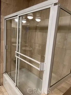 a bathroom with a glass shower door