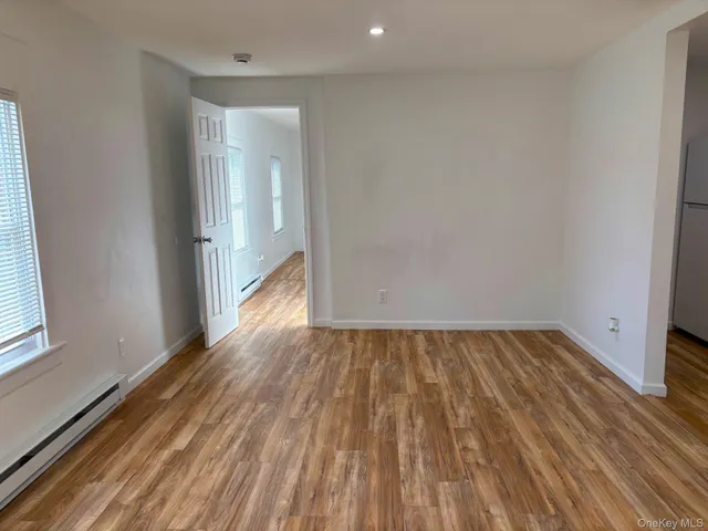 a view of an empty room and wooden floor
