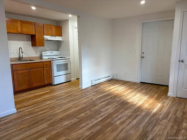 a view of a kitchen with wooden floor and a sink
