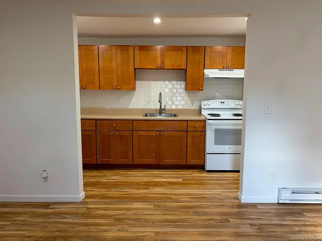 a view of kitchen with wooden floor and electronic appliances