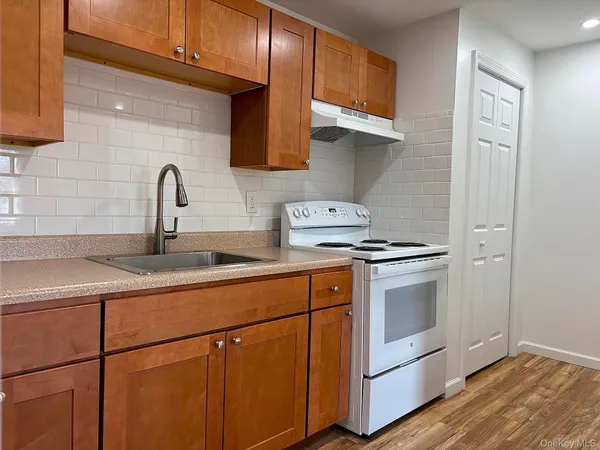 a kitchen with stainless steel appliances granite countertop a sink a stove and cabinets