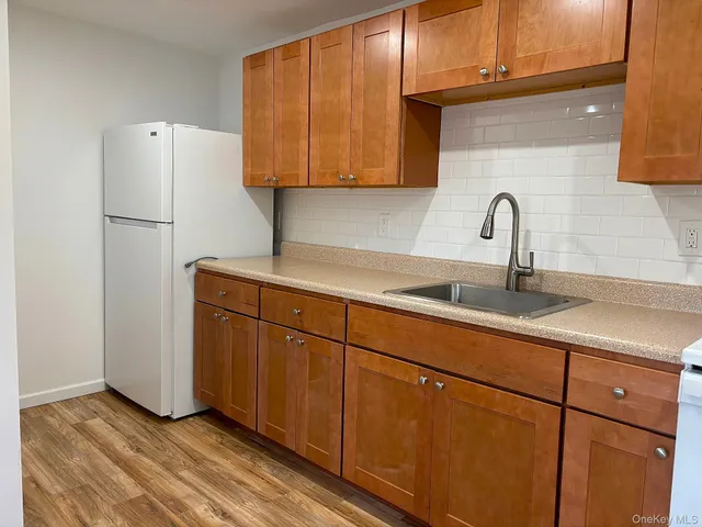 a kitchen with stainless steel appliances granite countertop a refrigerator sink and cabinets