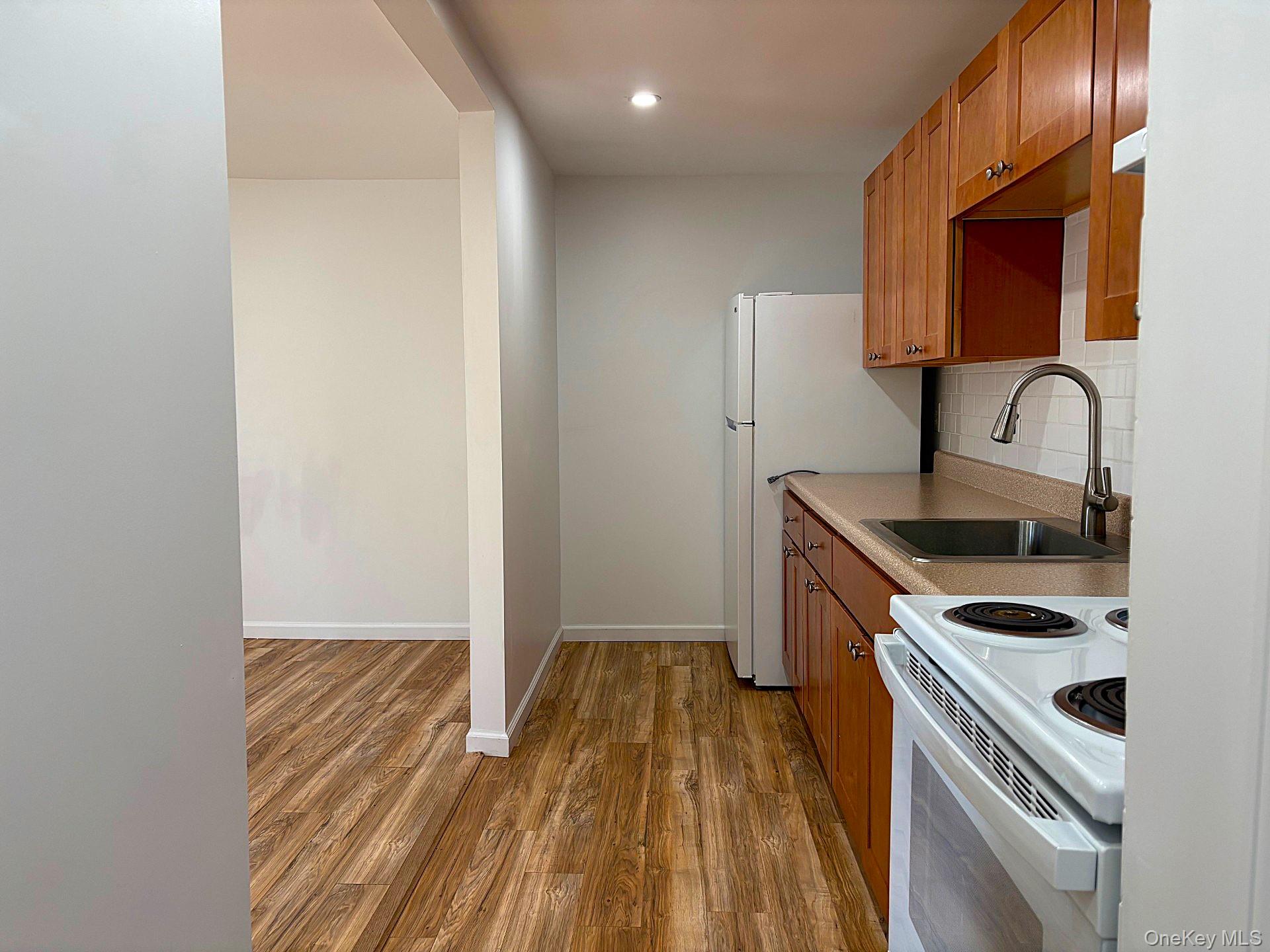 447 Highway 376, Unit 1 Hopewell Junction, NY 12533 - Photo 9 of 18 a kitchen with a sink a stove and cabinets