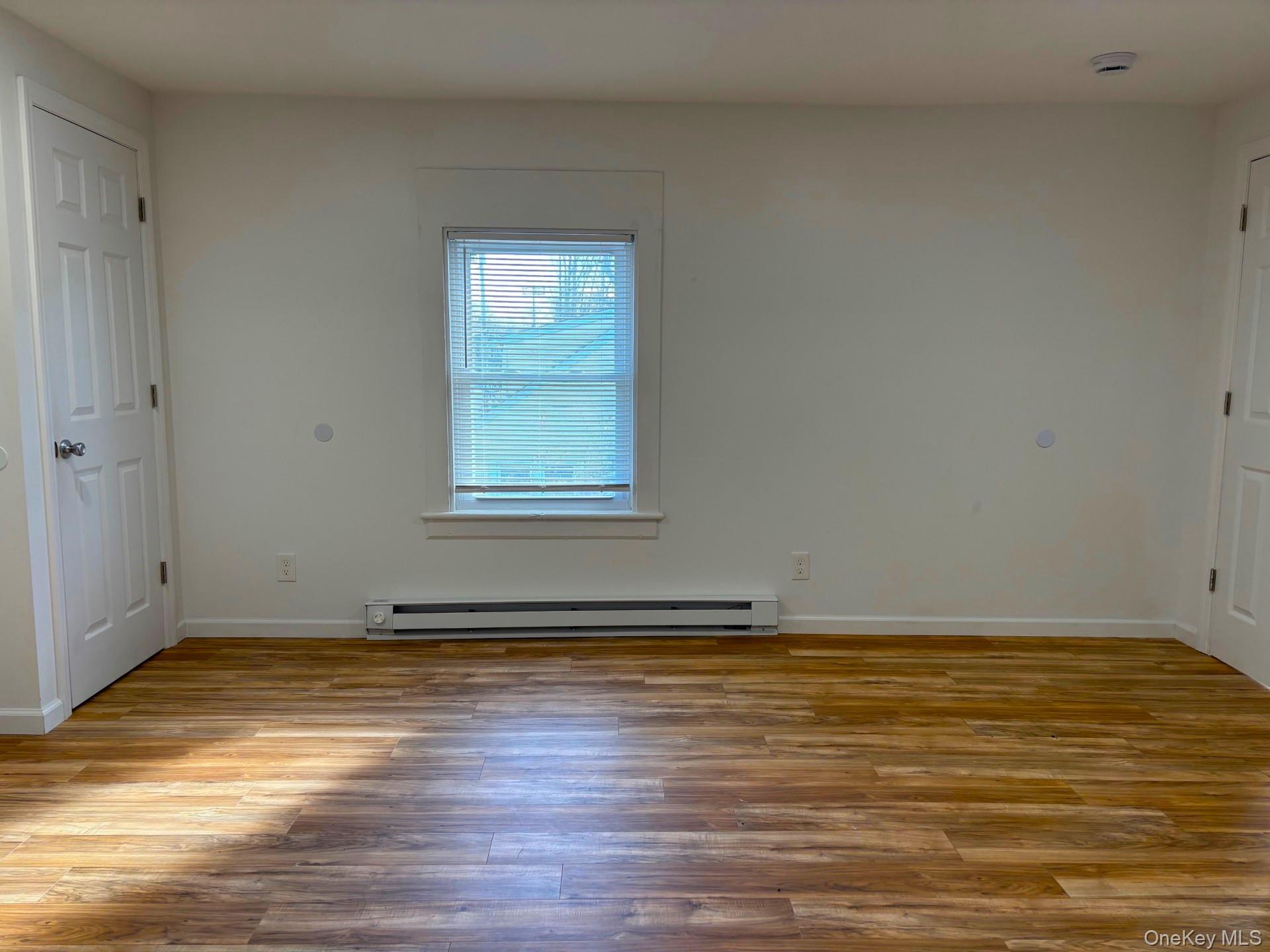 447 Highway 376, Unit 1 Hopewell Junction, NY 12533 - Photo 10 of 18 a view of an empty room with wooden floor and a window