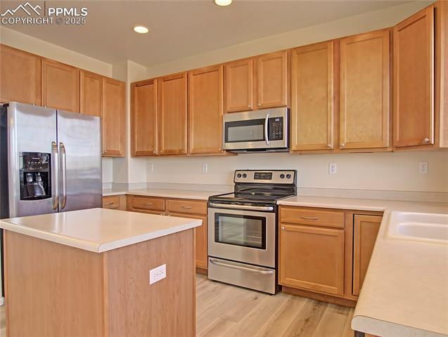 686 Pebble Crest Way Colorado Springs, CO 80921 - Photo 11 of 30 Kitchen boasts lots of cabinets and a pantry not shown in photos