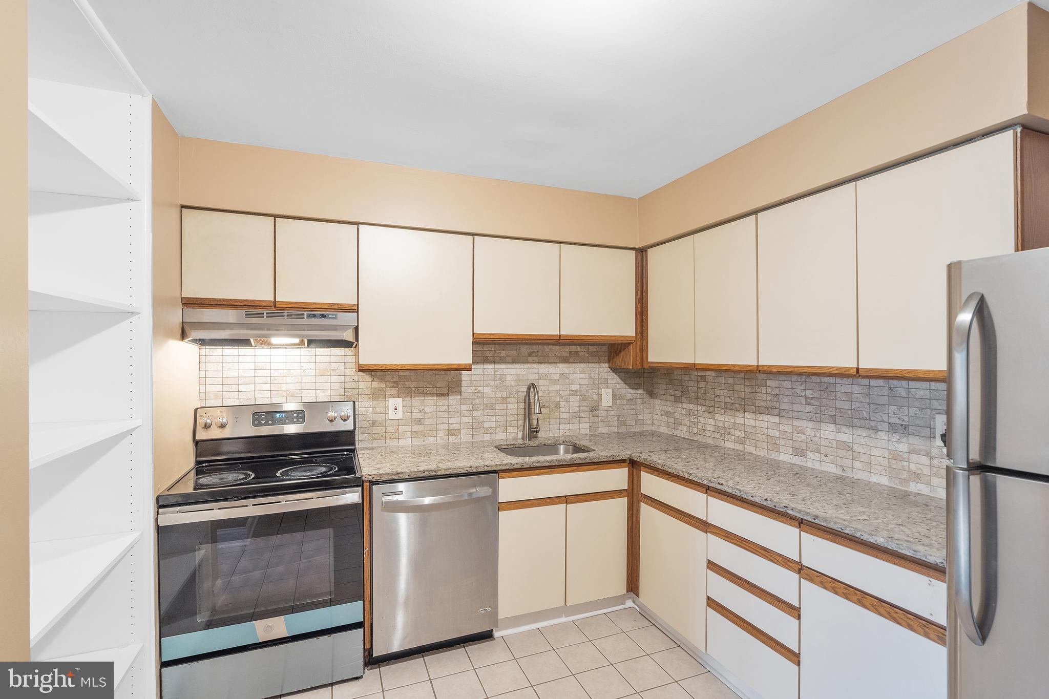 2 Avon Drive Hightstown, NJ 08520 - Photo 4 of 27 a kitchen with granite countertop white cabinets and white appliances