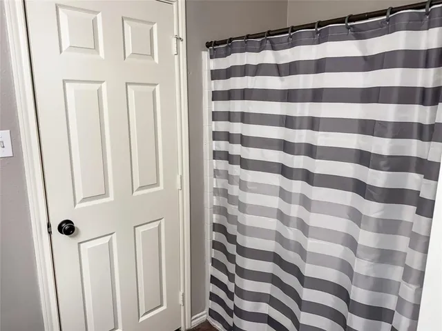 a view of a bathroom with a shower and a window