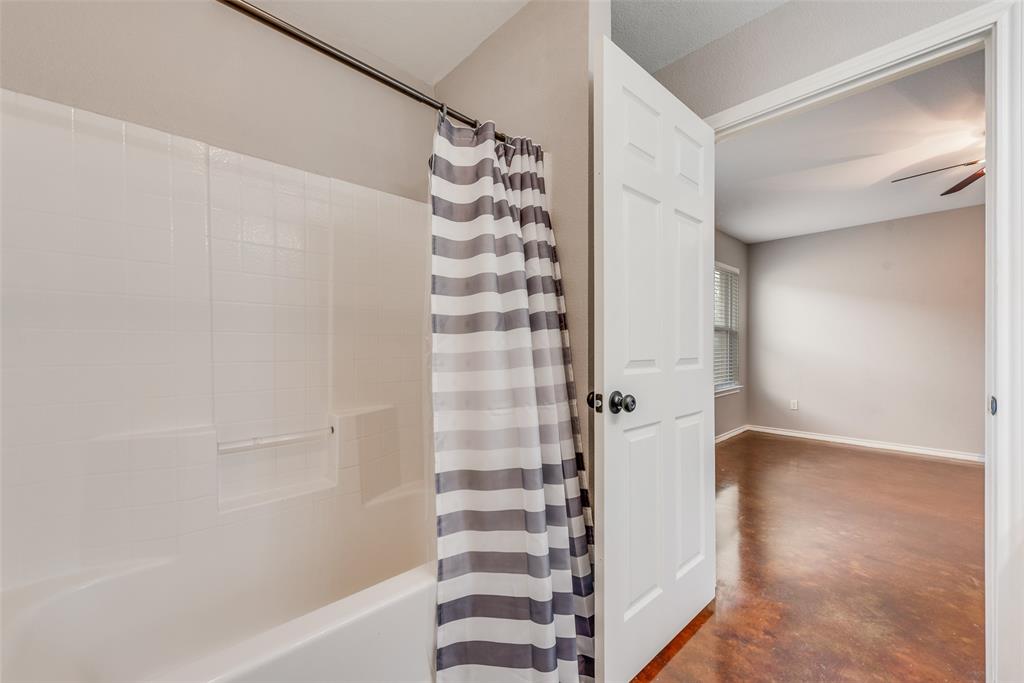 309 East 2nd Street Maypearl, TX 76064 - Photo 14 of 20 a bathroom with a bathtub and a shower