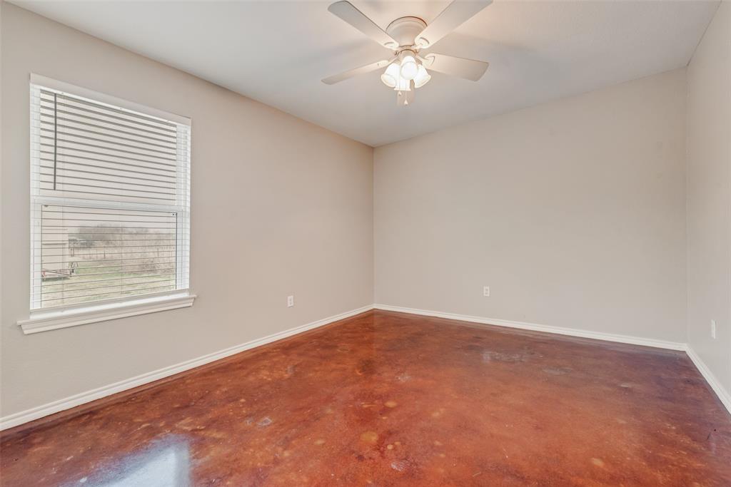 309 East 2nd Street Maypearl, TX 76064 - Photo 15 of 20 en empty room with windows and ceiling fan
