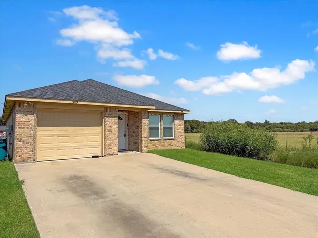a front view of a house with yard