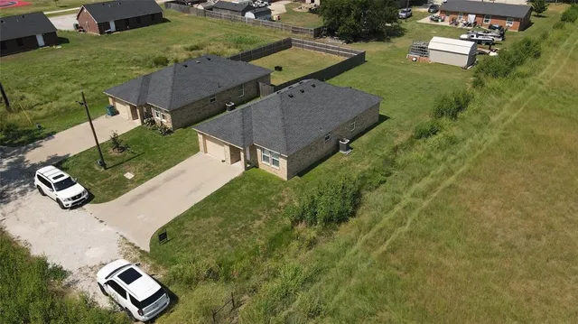 an aerial view of a house with a yard