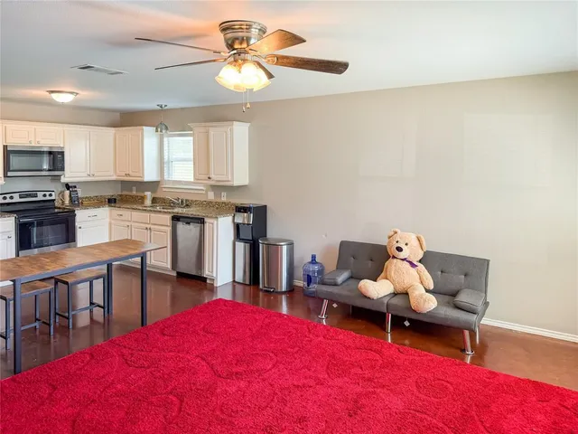 a kitchen with a table chairs stove and microwave