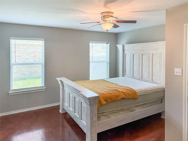 a bed sitting in a bedroom next to a window