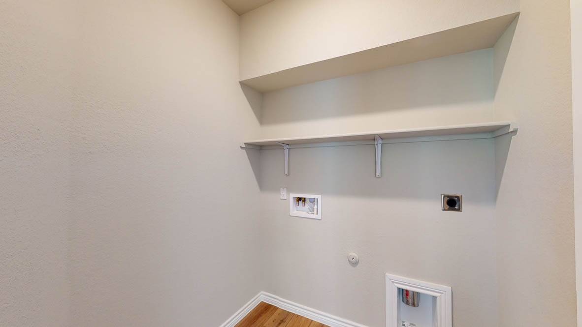 429 Creekfall Road Burnet, TX 78611 - Photo 27 of 28 Functional laundry space featuring ample shelving for organization.