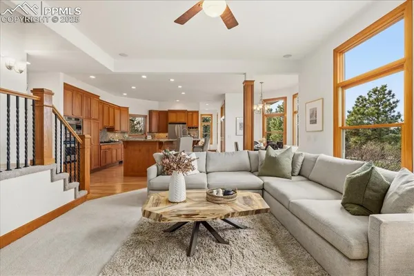 a kitchen with stainless steel appliances granite countertop a table chairs and a refrigerator