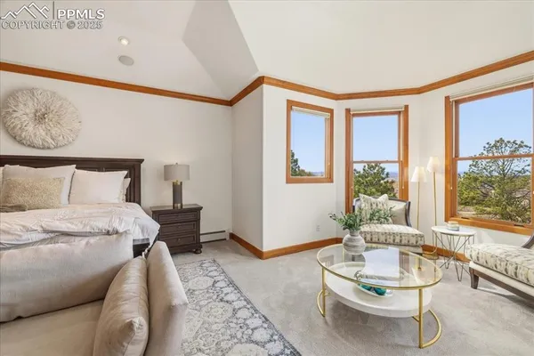 a living room with furniture a large window and a fireplace