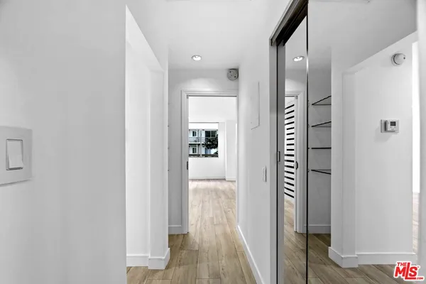 a view of a hallway with wooden floor