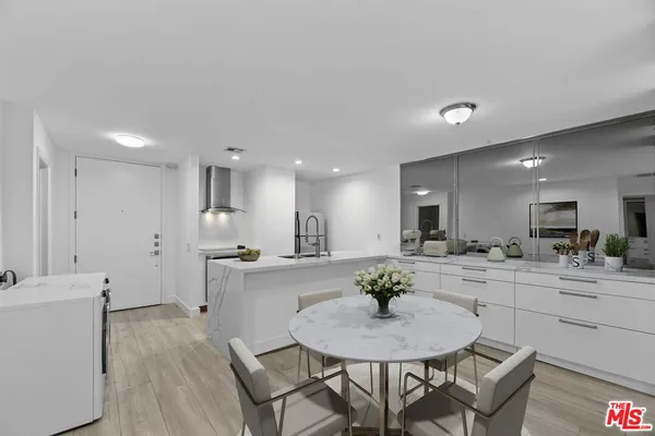 a large kitchen with a table and chairs