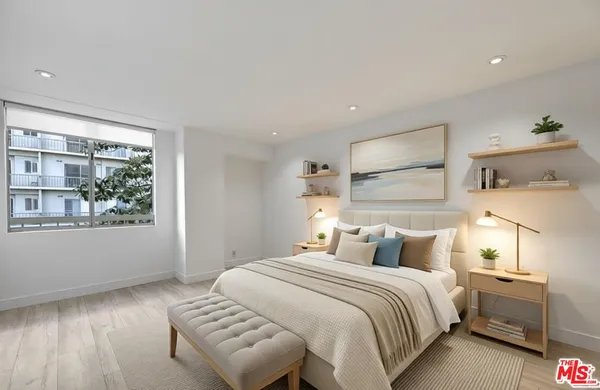 a bedroom with a large bed and a large window