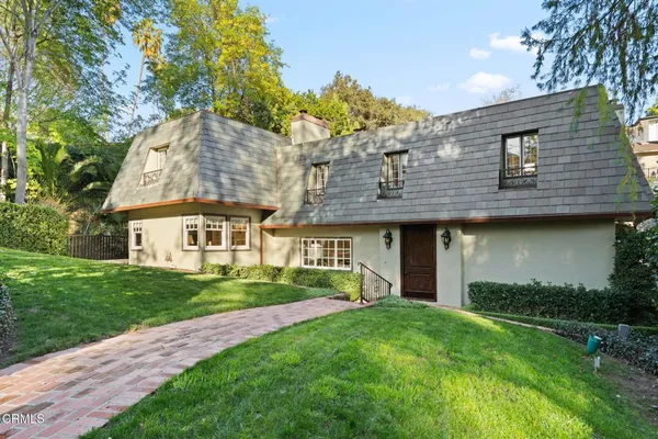 a view of a house with garden and yard