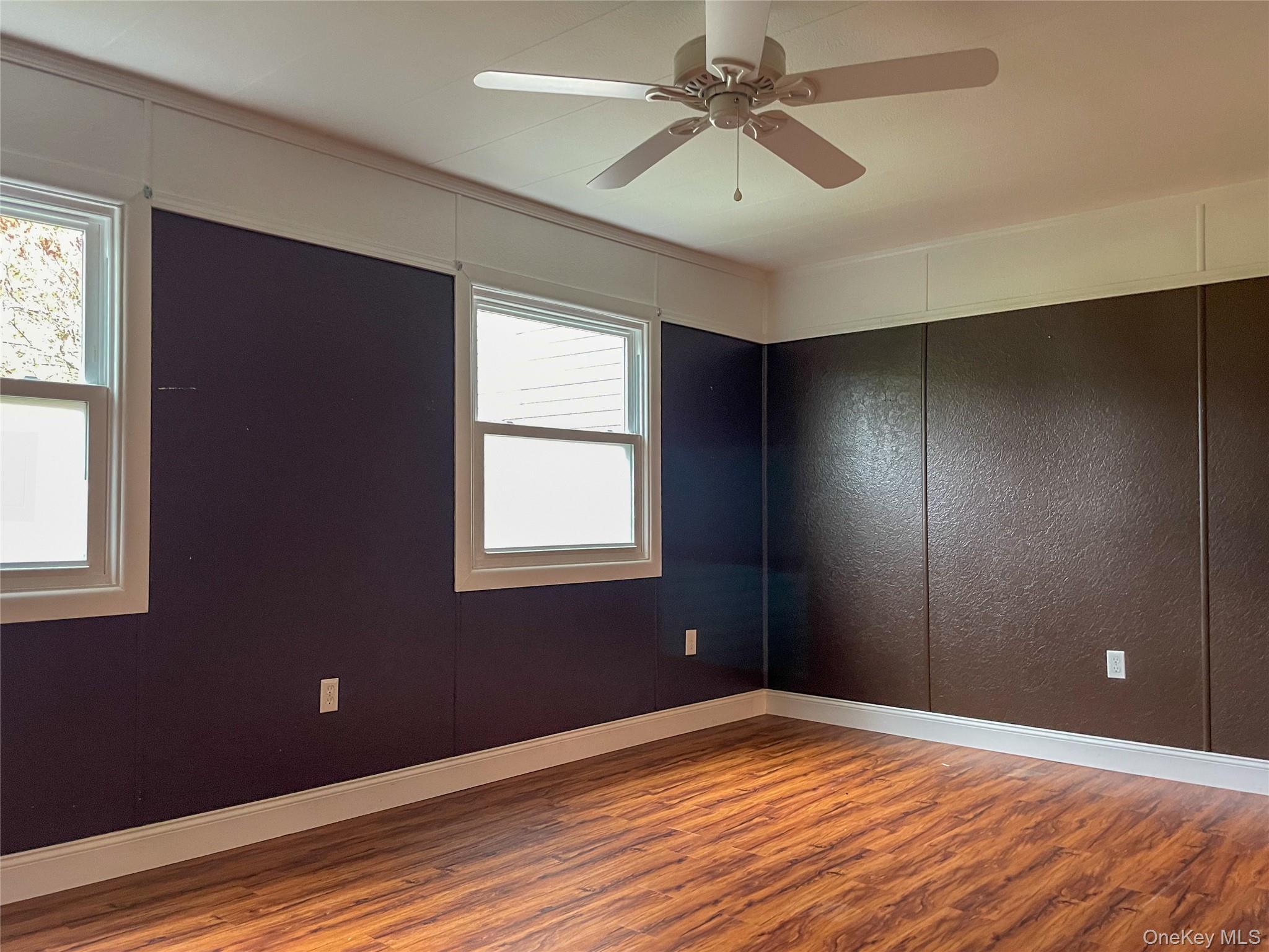 164 Rinaldi Boulevard, Unit B Poughkeepsie, NY 12601 - Photo 12 of 15 a view of empty room with wooden floor and fan
