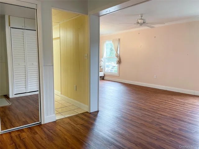a view of hallway with wooden floor
