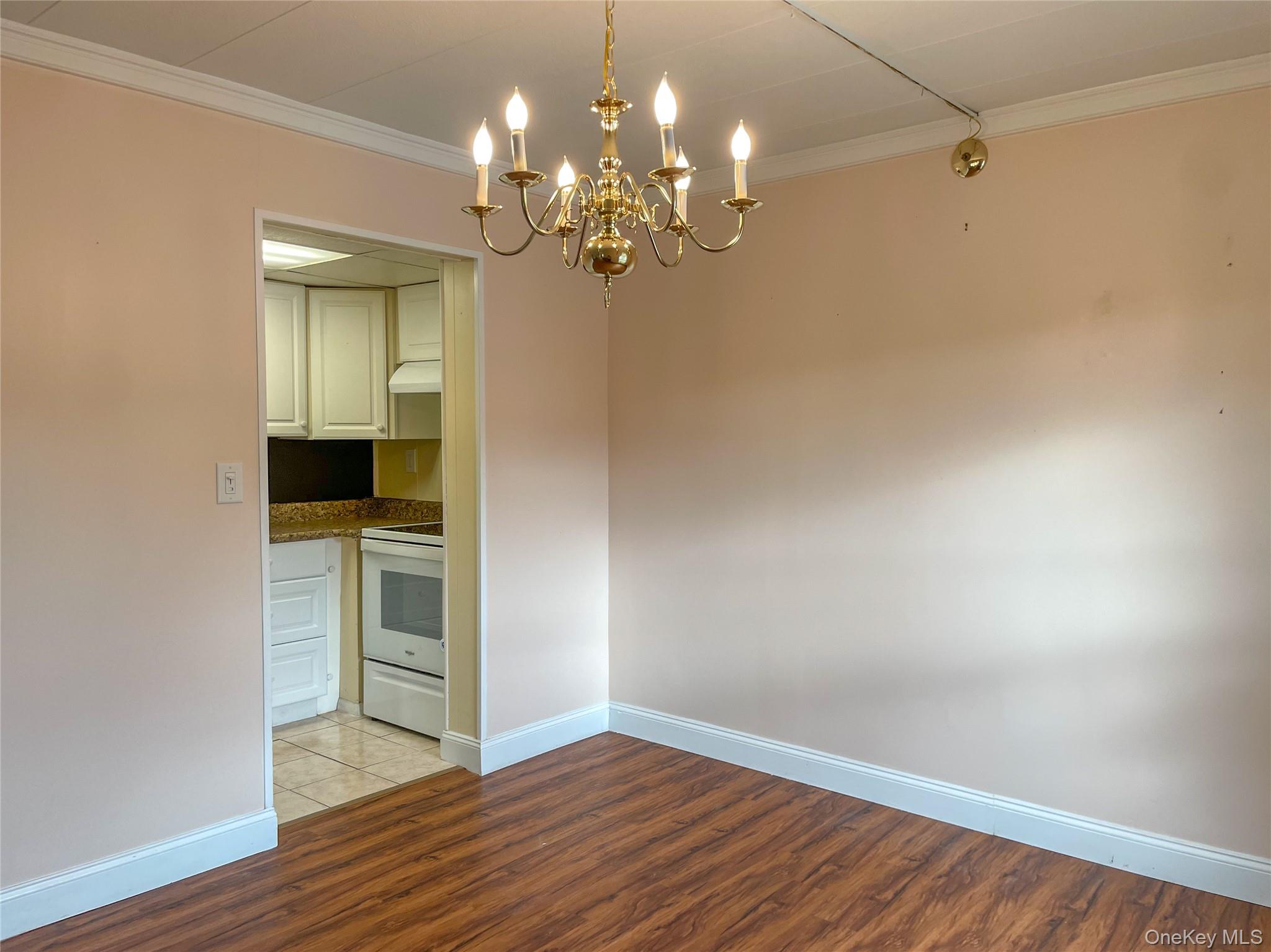 164 Rinaldi Boulevard, Unit B Poughkeepsie, NY 12601 - Photo 8 of 15 a view of a room with wooden floor and chandelier