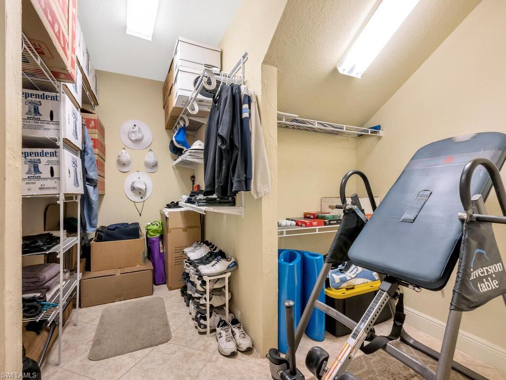 10540 Marino Pointe Drive, Unit 301 Miromar Lakes, FL 33913 - Photo 16 of 43 a view of walk in closet with clothes and shoes
