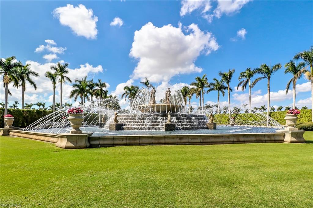 10540 Marino Pointe Drive, Unit 301 Miromar Lakes, FL 33913 - Photo 29 of 43 a view of a swimming pool with a garden