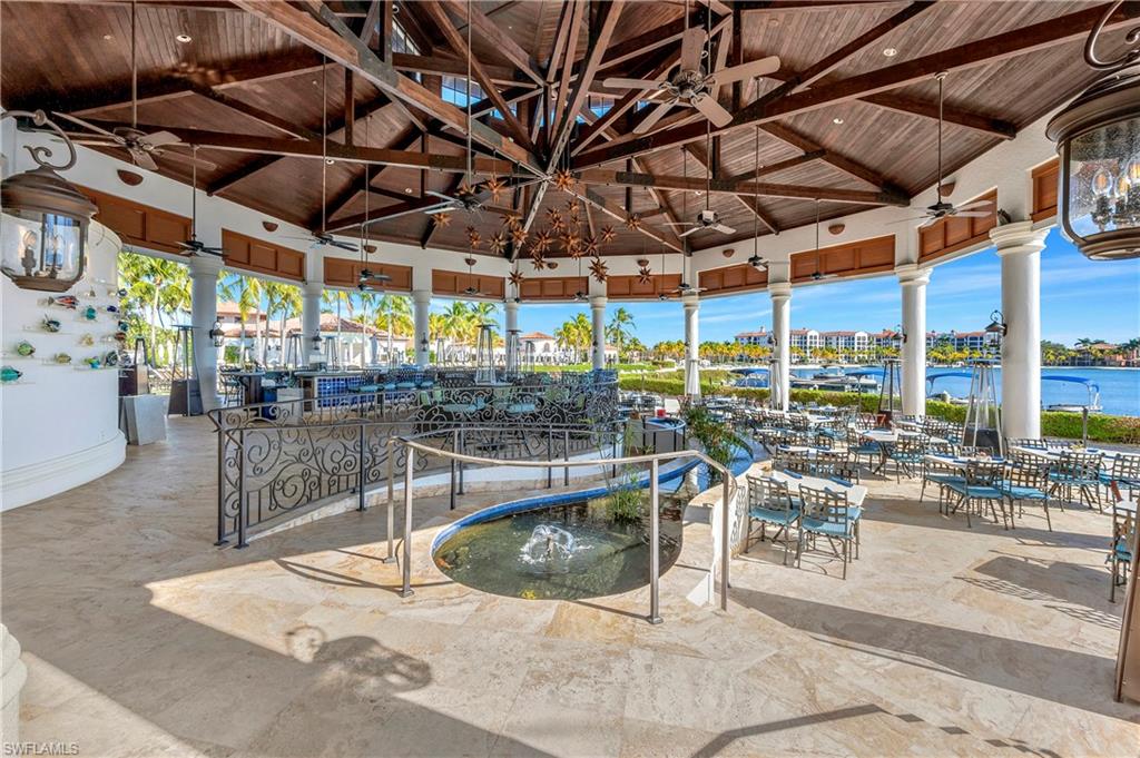 10540 Marino Pointe Drive, Unit 301 Miromar Lakes, FL 33913 - Photo 31 of 43 a view of a swimming pool with outdoor seating
