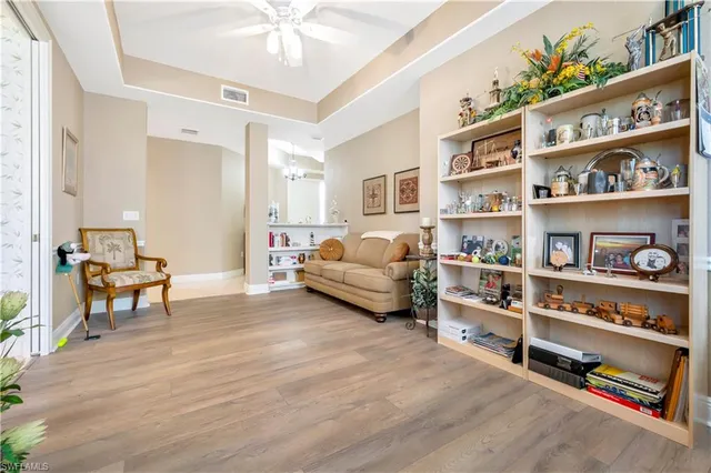 a living room with furniture and a book shelf