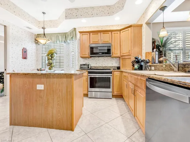 a kitchen with stainless steel appliances a stove sink and cabinets