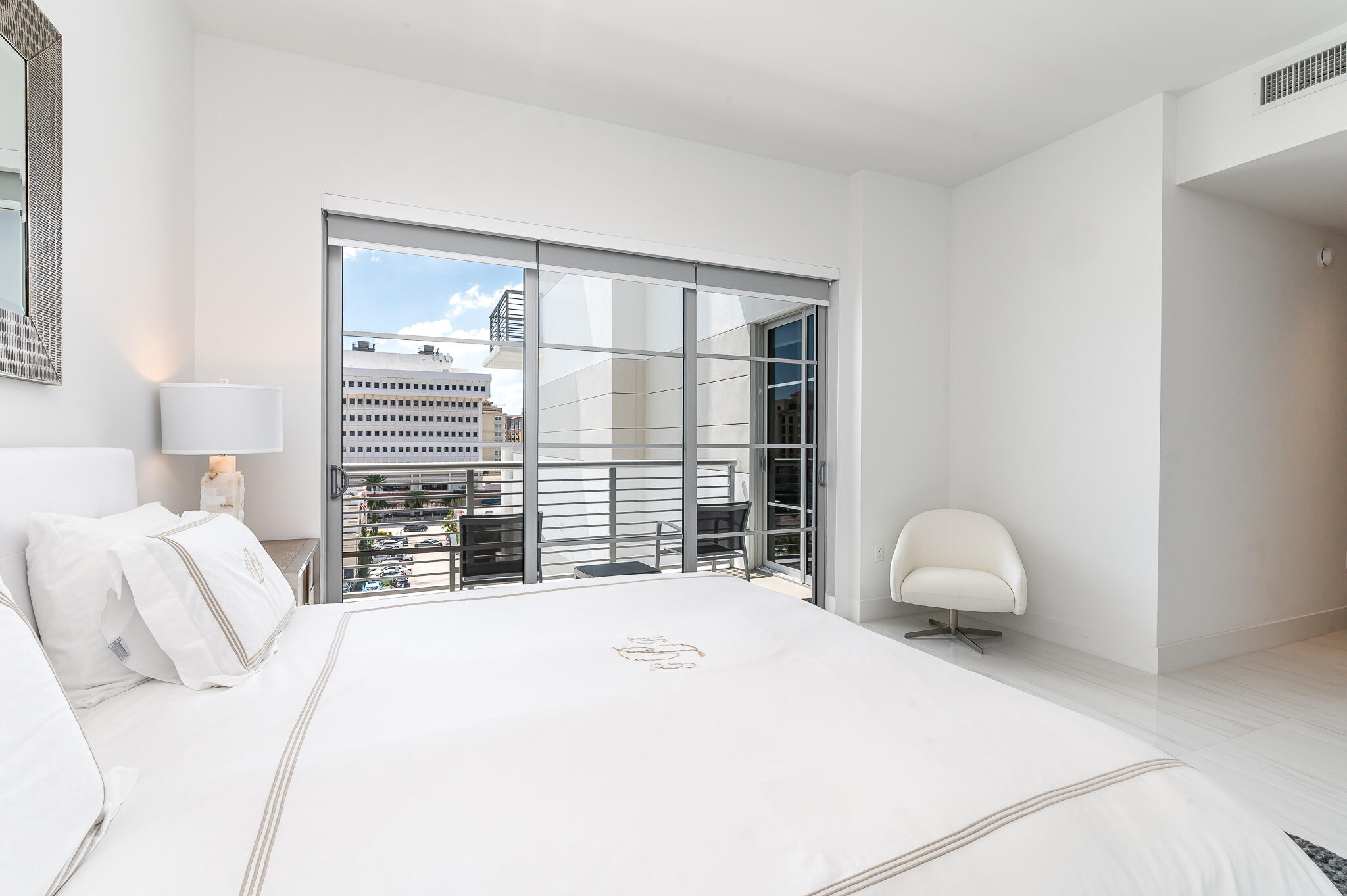 155 East Boca Raton Road, Unit 614 Boca Raton, FL 33432 - Photo 16 of 55 a bedroom with a bed and a large window