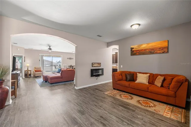 a living room with furniture and a wooden floor