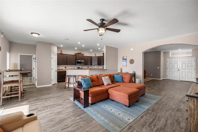 a living room with furniture and kitchen view
