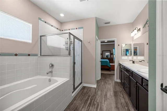 a bathroom with a bathtub a sink and a mirror