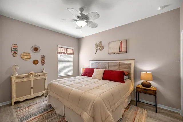 a bedroom with a large bed and a chandelier