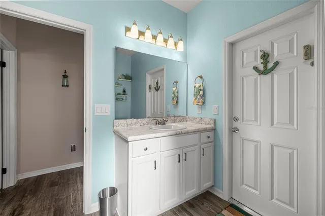 a bathroom with a granite countertop sink and a mirror
