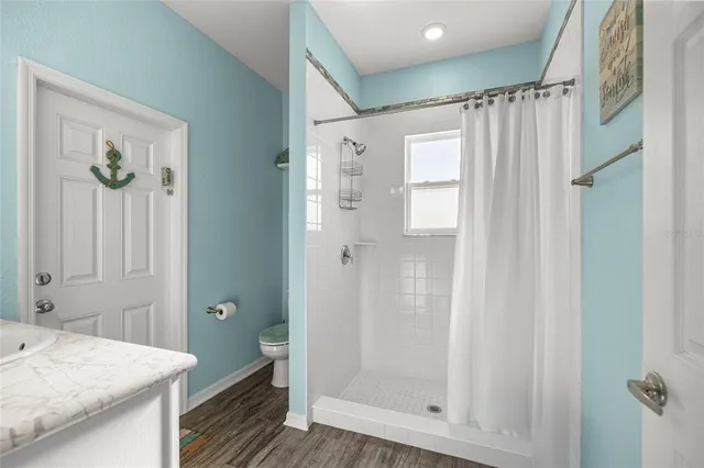 a bathroom with a shower a sink and a mirror