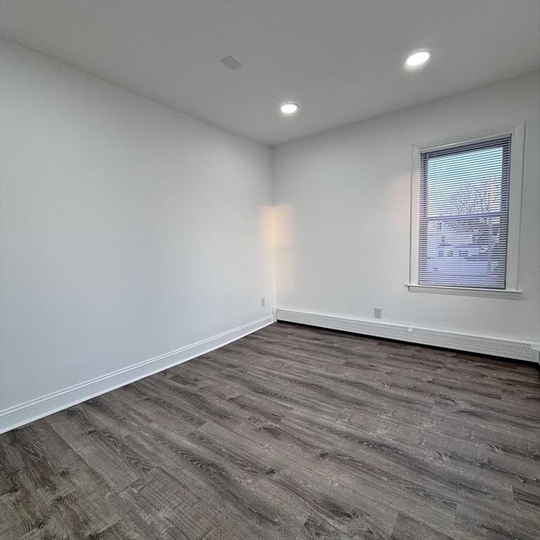 12 Pine Street, Unit 2 Attleboro, MA 02703 - Photo 12 of 20 an empty room with wooden floor and windows
