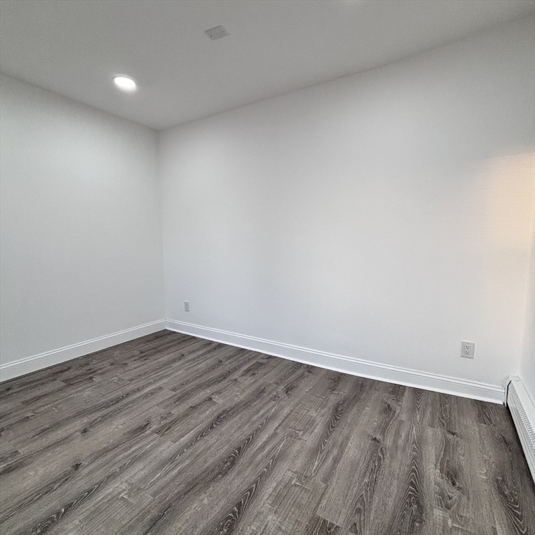 12 Pine Street, Unit 2 Attleboro, MA 02703 - Photo 14 of 20 a view of an empty room with wooden floor