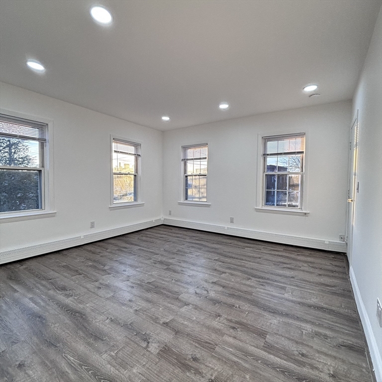 12 Pine Street, Unit 2 Attleboro, MA 02703 - Photo 15 of 20 an empty room with wooden floor and windows