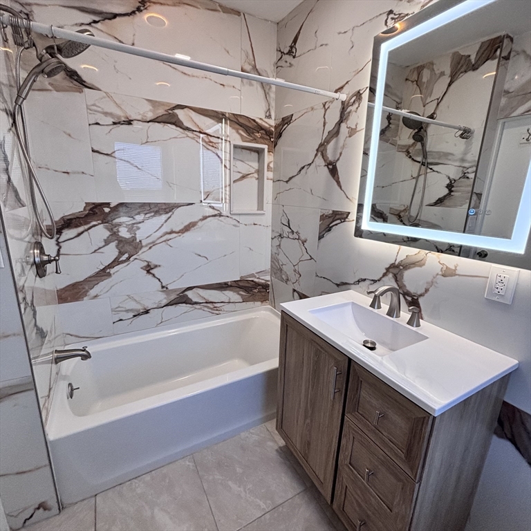 12 Pine Street, Unit 2 Attleboro, MA 02703 - Photo 2 of 20 a bathroom with a sink vanity tub and a mirror