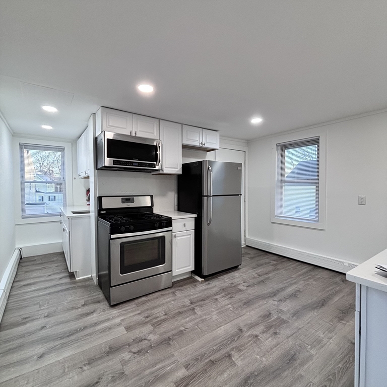 12 Pine Street, Unit 2 Attleboro, MA 02703 - Photo 4 of 20 a kitchen with stainless steel appliances a refrigerator and a stove top oven