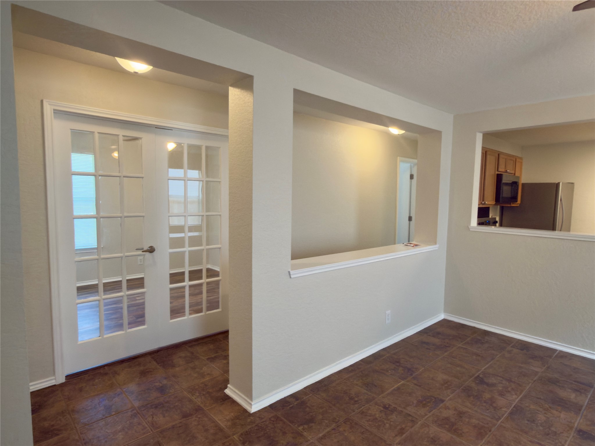 255 Myrtle Street Kyle, TX 78640 - Photo 9 of 31 Entryway featuring French doors with glass panes, leading to an interior space with wood-finish flooring
