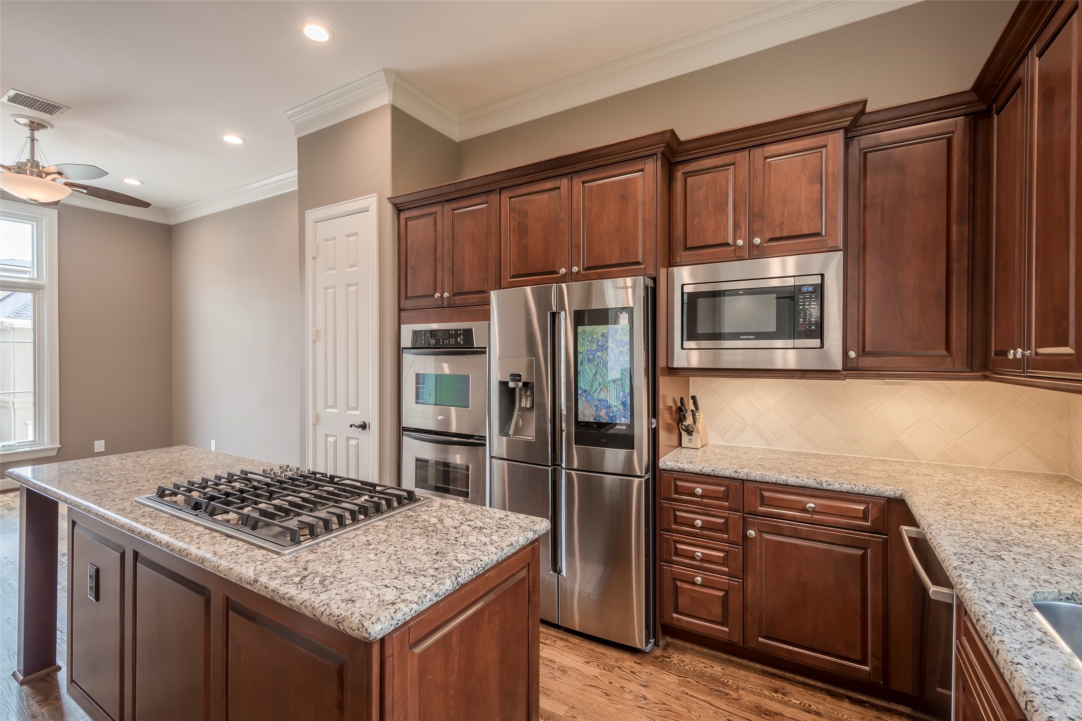6334 Mystic Bridge Drive Houston, TX 77021 - Photo 21 of 47 a kitchen with kitchen island granite countertop stainless steel appliances and wooden cabinets